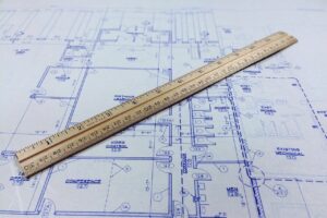 Photo of a ruler on a blueprint.