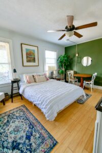 white bed linen on bed in studio apartment