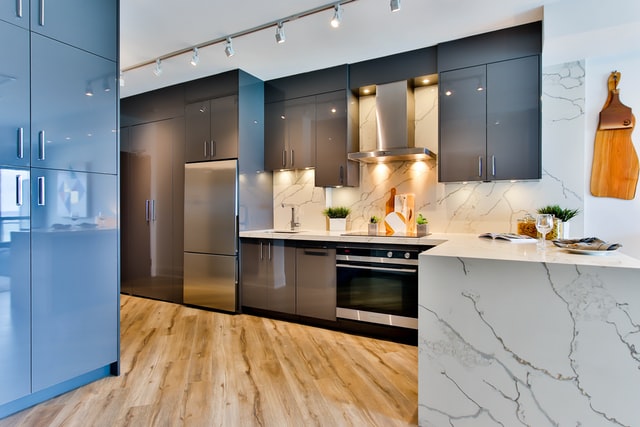Under-cabinet lighting illuminates a beautiful marble backsplash and countertop.