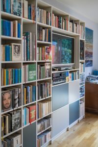 A built-in bookshelf filled with books.