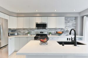 Photograph of a modern white and grey kitchen