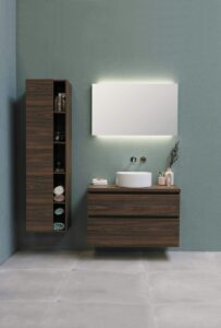 A photograph of a modern bathroom with wood cabinetry and a floating vanity.